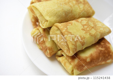 Pancakes with meat on a plate. Delicious envelopes with meat. Pancakes with meat on a plate. Delicious envelopes with meat. 115241438