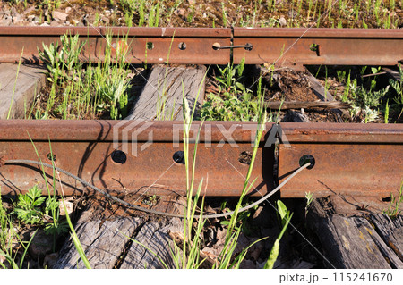Old rusty railroad rail joint gap closeup 115241670