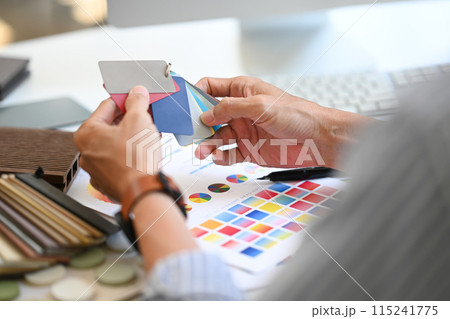 Close up Interior designer holding color samples working on new design project at office 115241775