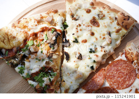 Meat pizza on a wooden stand. Delicious Italian pizza. 115241901