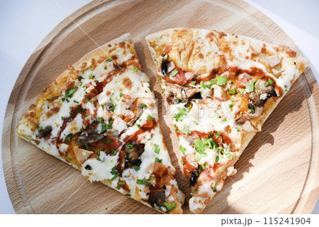 Meat pizza on a wooden stand. Delicious Italian pizza. Meat pizza on a wooden stand. Delicious Italian pizza. 115241904