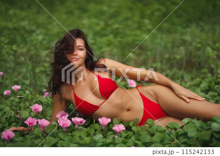 Creative Fashion Photo of Bikini Beach Model in Red Swimsuit on Flower Meadow 115242133