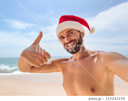 Selfie Photo of Bearded Beach Man with Thumb up of Christmas Holidays Selfie Photo of Bearded Beach Man with Thumb up of Christmas Holidays 115242159