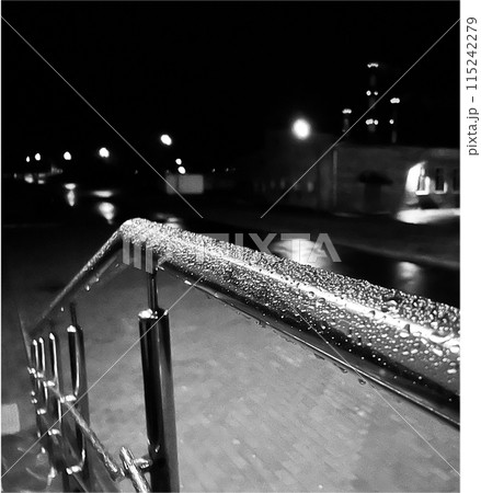raindrops at night under a lantern on a metal pipe raindrops at night under a lantern on a metal pipe 115242279