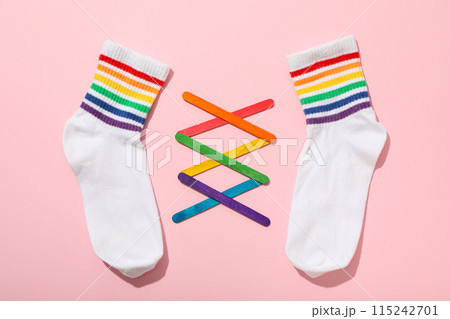 LGBT parade concept, holiday symbols on pink background. LGBT parade concept, holiday symbols on pink background. 115242701