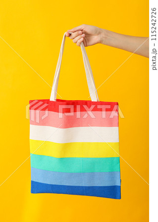Concept of lgbt parade, rainbow shopper, on color background. 115242726