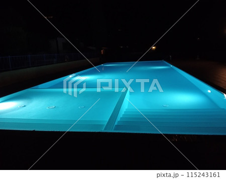 swimming pool illuminated at night outdoors swimming pool illuminated at night outdoors 115243161