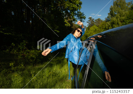 A stopover in the forest on the side of the road during long journeys by passenger car for a dream vacation. A stopover in the forest on the side of the road during long journeys by passenger car for a dream vacation. 115243357