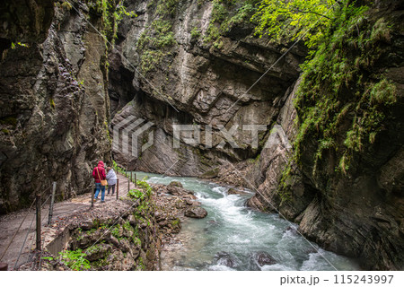 Hiking through the scenic Partnach gorge near Garmisch-Partenkirchen in the Bavarian Alps 115243997