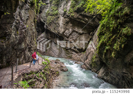 Hiking through the scenic Partnach gorge near Garmisch-Partenkirchen in the Bavarian Alps Hiking through the scenic Partnach gorge near Garmisch-Partenkirchen in the Bavarian Alps 115243998