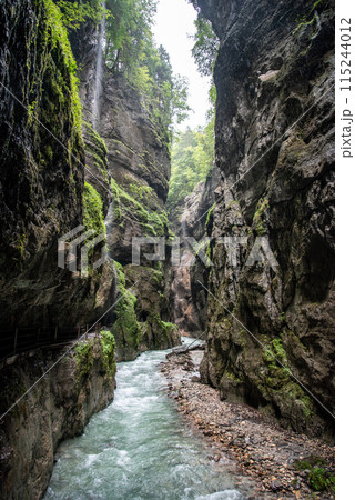 Hiking through the scenic Partnach gorge near Garmisch-Partenkirchen in the Bavarian Alps 115244012
