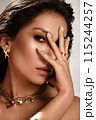 Beautiful tanned woman with smoky makeup, gold jewelry and ice. Beauty face. 115244257