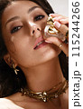 Beautiful tanned woman with smoky makeup, gold jewelry and ice. Beauty face. 115244266