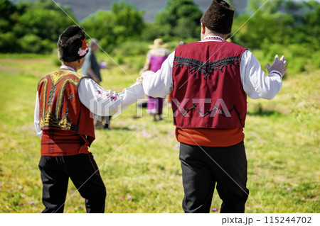Men dancing dressed in traditional clothing. Annual Rose picking ritual in Bulgaria 115244702