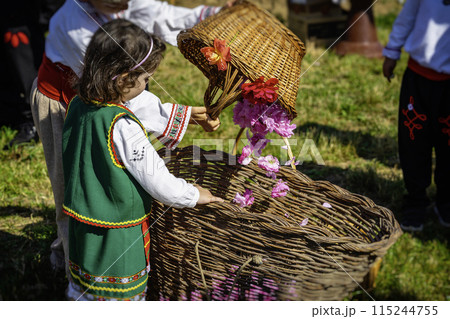 Little girl dressed in traditional dress with basket of rose petals, Annual Rose Festival in Kazanlak, Bulgaria Little girl dressed in traditional dress with basket of rose petals, Annual Rose Festival in Kazanlak, Bulgaria 115244755