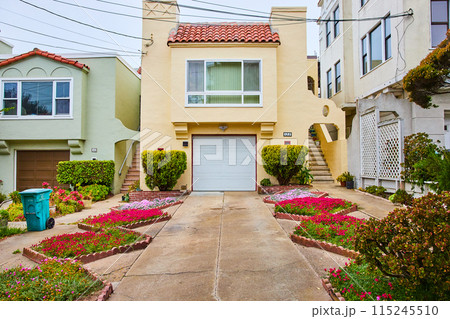 Driveway leading to yellow San Francisco home with wavy landscape full of red and purple flowers Driveway leading to yellow San Francisco home with wavy landscape full of red and purple flowers 115245510