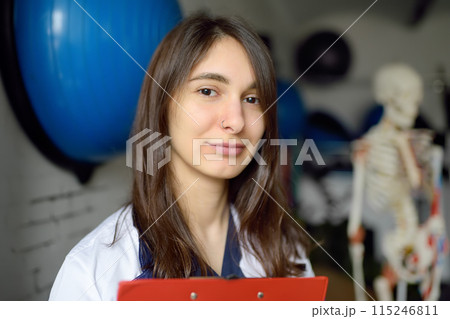 Rehab doctor is on appointment of patient in gym. PMR specialized in physically-based rehabilitation and recovery. This treat using exercises and orthopedics. Rehab doctor is on appointment of patient in gym. PMR specialized in physically-based rehabilitation and recovery. This treat using exercises and orthopedics. 115246811