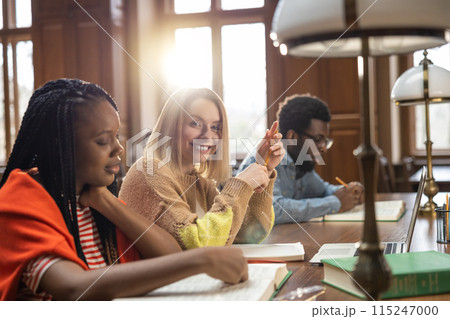 Group of students studying in the library together Group of students studying in the library together 115247000