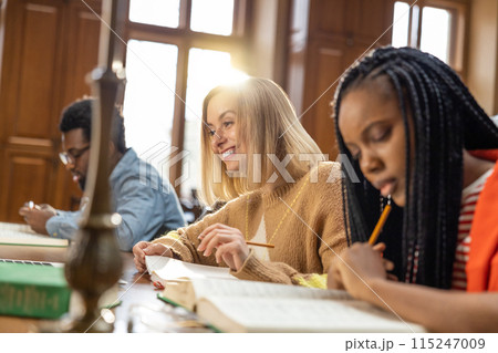 Group of young people working on the project together and looking involved 115247009