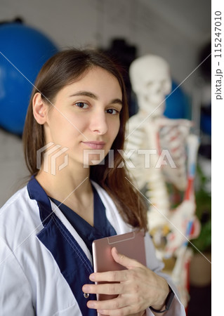 Rehab doctor is on appointment of patient in gym. PMR specialized in physically-based rehabilitation and recovery. This treat using exercises and orthopedics. 115247010