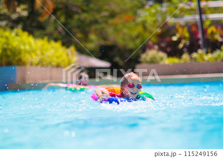 Child in swimming pool on toy ring. Kids swim. Child in swimming pool on toy ring. Kids swim. 115249156