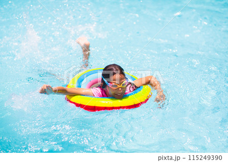 Child in swimming pool on toy ring. Kids swim. Child in swimming pool on toy ring. Kids swim. 115249390