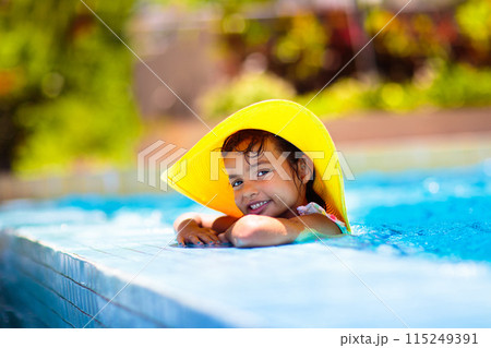 Child in swimming pool on ring toy. Kids swim. Child in swimming pool on ring toy. Kids swim. 115249391