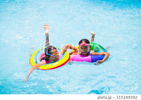 Child in swimming pool on toy ring. Kids swim. Child in swimming pool on toy ring. Kids swim. 115249392