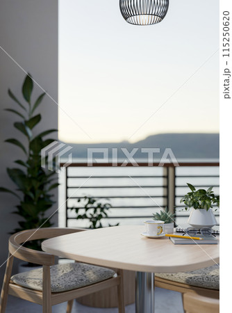 A wooden table with armchairs on a balcony with decorative plants and a beautiful nature view. 115250620