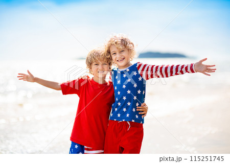 Kids with American flag on beach. 4th of July. Kids with American flag on beach. 4th of July. 115251745