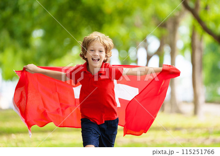 Child running with Switzerland flag. Swiss fan. Child running with Switzerland flag. Swiss fan. 115251766