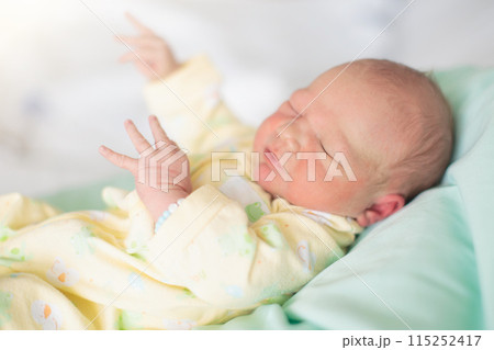 Newborn baby boy in hospital cot Newborn baby boy in hospital cot 115252417