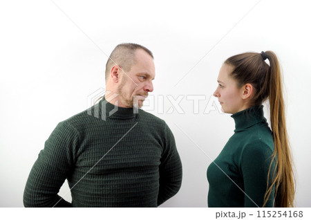 Photo of attractive confident sister brother wear green sweater hands crossed looking each other isolated grey color background Photo of attractive confident sister brother wear green sweater hands crossed looking each other isolated grey color background 115254168