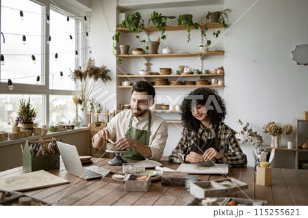 Man and woman sculpting pottery watching online video course 115255621