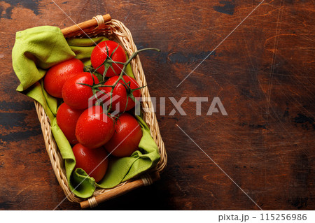 Fresh tomatoes in basket Fresh tomatoes in basket 115256986