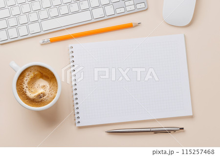 Office desk table with notepad, cup of coffee and supplies 115257468