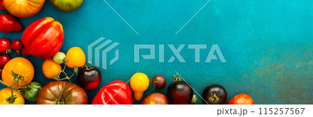 Tomatoes on an emerald green background Tomatoes on an emerald green background 115257567