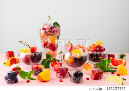 Drinks with ice cubes with berries and fruits 115257585