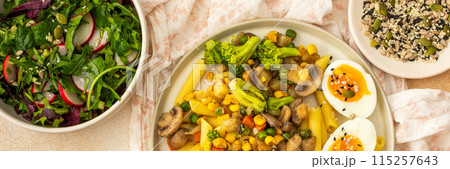 Pasta with fried mushrooms and broccoli, green peas and corn, fresh mix salad Pasta with fried mushrooms and broccoli, green peas and corn, fresh mix salad 115257643