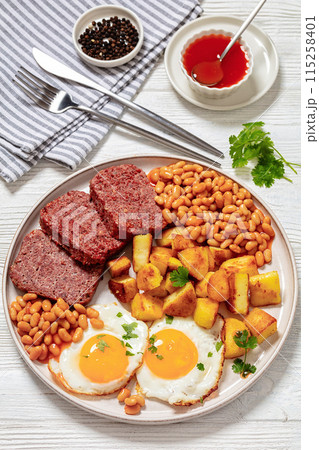 corned beef, baked beans, potatoes and fried eggs 115258401