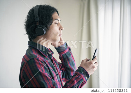 スマホで音楽を聴く若い男性 スマホで音楽を聴く若い男性 115258831