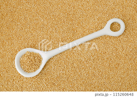 Amaranth grain seeds in ceramic spoon as a background. Top view. Flat lay Amaranth grain seeds in ceramic spoon as a background. Top view. Flat lay 115260648