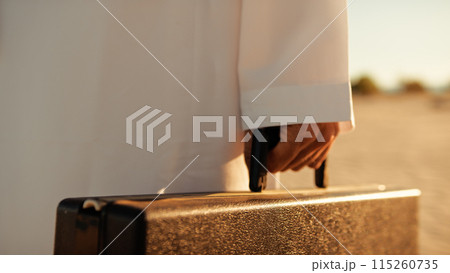 Sun Hitting The Black Briefcase In The Sheik's Hand  115260735