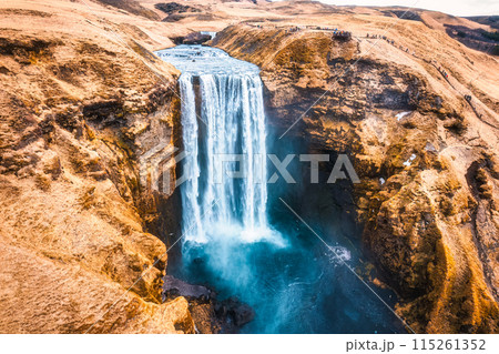 Powerful Skogafoss waterfall flowing with dry mountain in autumn at Iceland Powerful Skogafoss waterfall flowing with dry mountain in autumn at Iceland 115261352