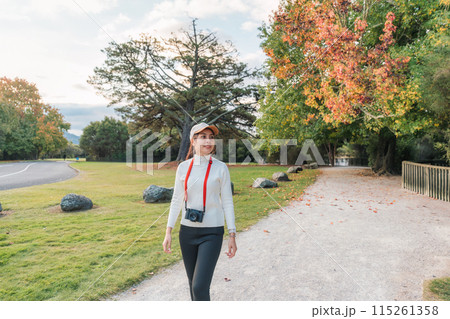 Beautiful asian woman walking in autumn park at Cornwall park, New Zealand 115261358