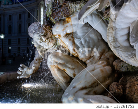 Vienna, Austria, August 17, 2022. Night shot of the fountain next to the entrance of the Hofburg Imperial Palace. The artificial light and the water features enhance the realism of the marble statue. 115261752