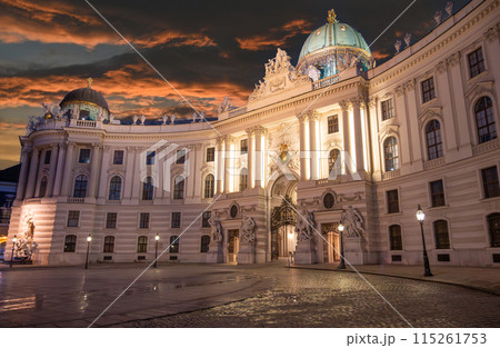 Vienna, Austria, August 17, 2022. Magnificent night view of the Hofburg Imperial Palace, the illumination enhances the imposing facade. People in the square. 115261753