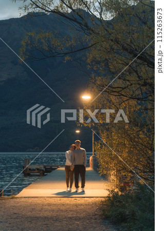 Asian couple enjoying on wooden pier under the light at Glenorchy, New Zealand Asian couple enjoying on wooden pier under the light at Glenorchy, New Zealand 115263673