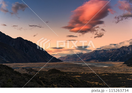 Sunrise over rocky mountain range on dry field in autumn 115263734