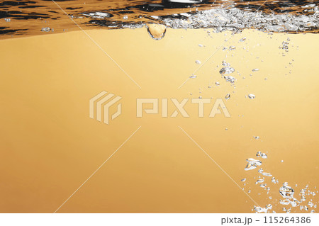 Different waves of air bubbles caused by falling water on a colorful background. 115264386